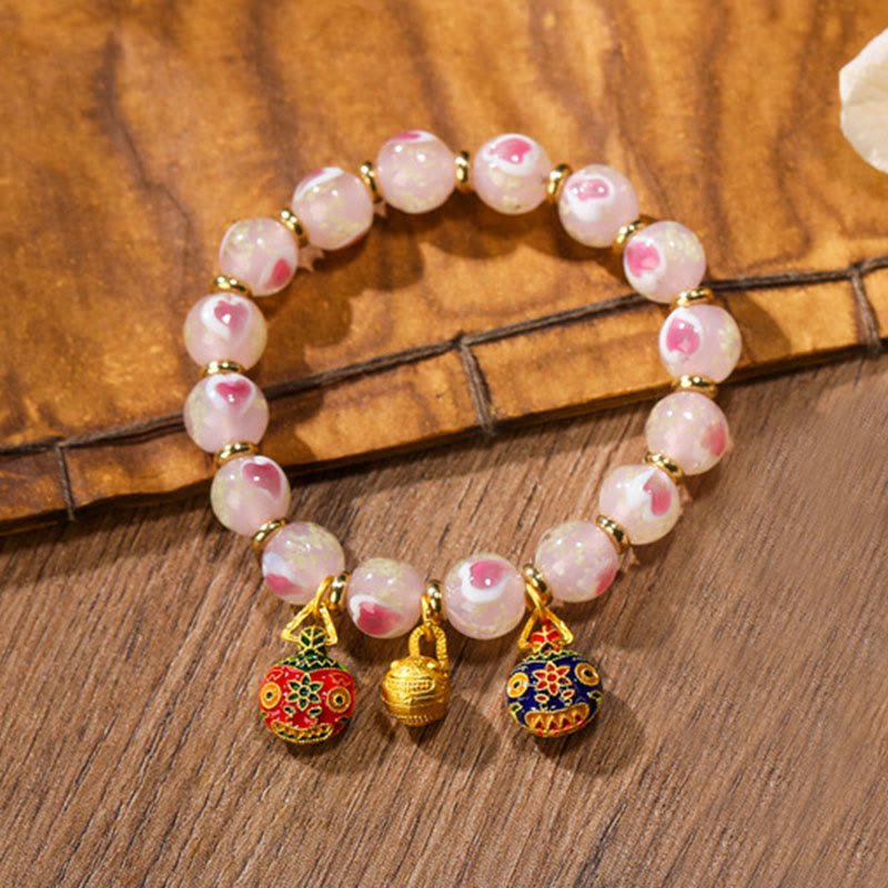 Bracelet spirituel en forme de cœur rose lumineux avec une bête avaleuse en or