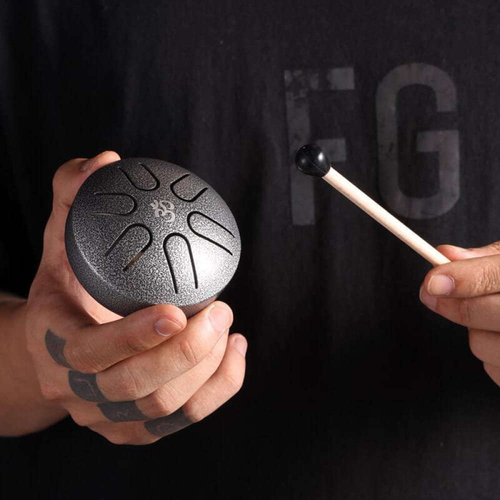 Mini Titanium Steel Tongue Drum being played with a mallet, musical instrument