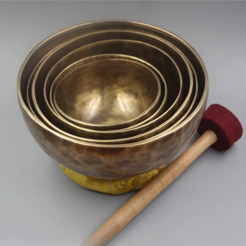 Nested brass singing bowls with a wooden mallet from Nepal Handmade Tibetan Singing Bowl