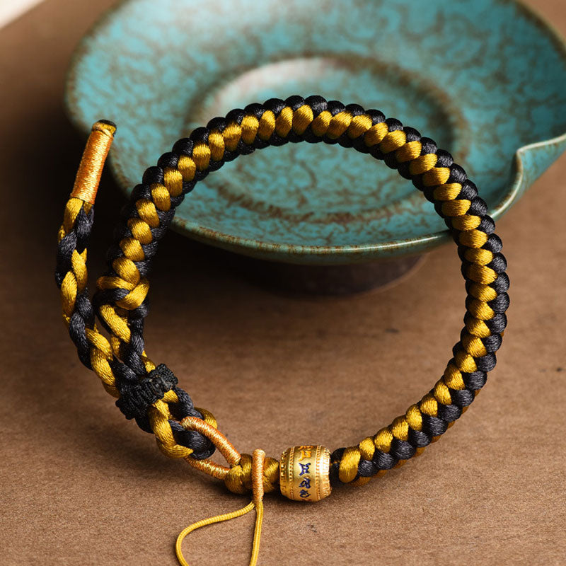 Bracelet en corde noire et or tibétain Om Mani Padme Hum