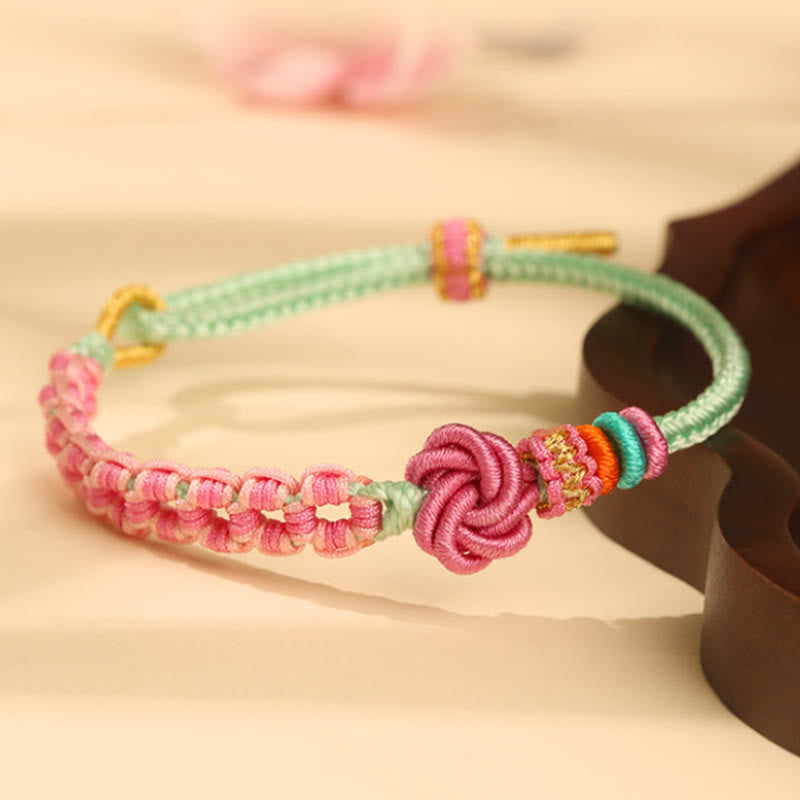 Bracelet en fil rouge avec nœud en fleur de pêcher pour la protection et l'amour