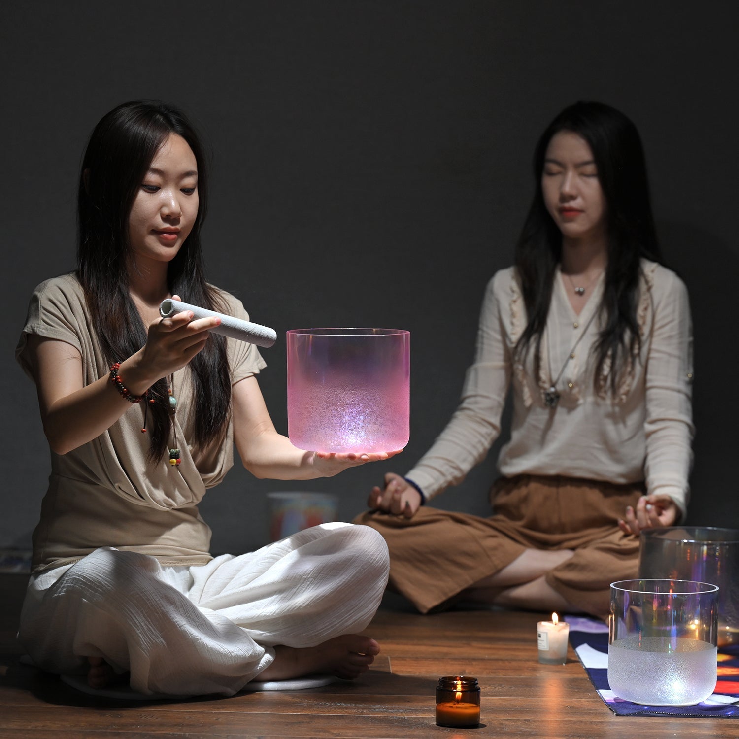 Glowing pink cylindrical glass vessel with illuminated liquid in Pink Snow Flower Crystal Singing Bowl