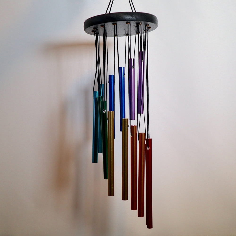 Rainbow-colored wind chimes with metal tubes in a spiral pattern for natural melodies