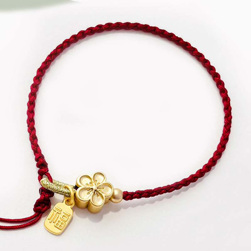 Bracelet en fil rouge avec breloque Fu et détail fleur de pêcher