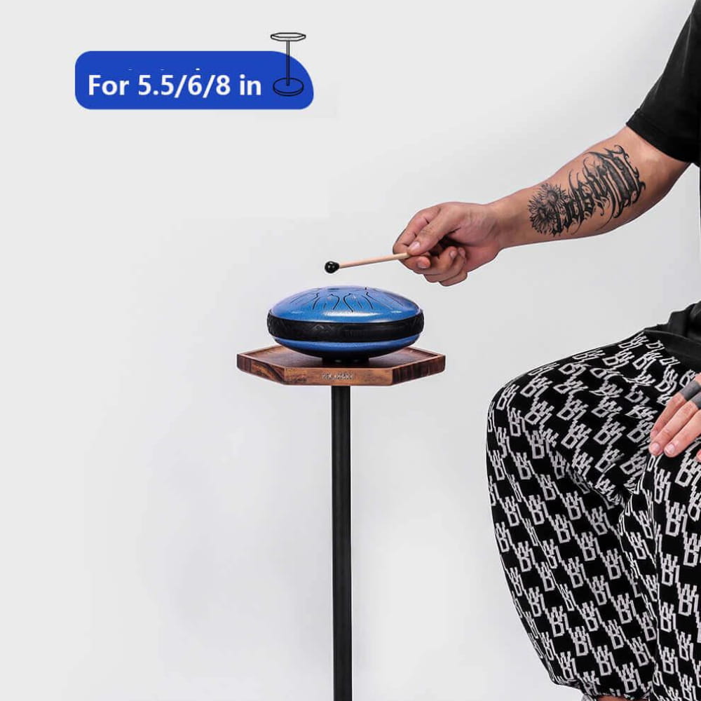 Blue metallic tongue drum on a wooden hexagonal stand with a black pole base