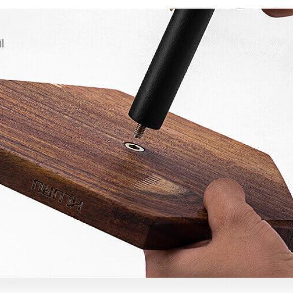 Black screwdriver tightening screws on a wooden surface for Solid Wood Stand for Steel Tongue Drums
