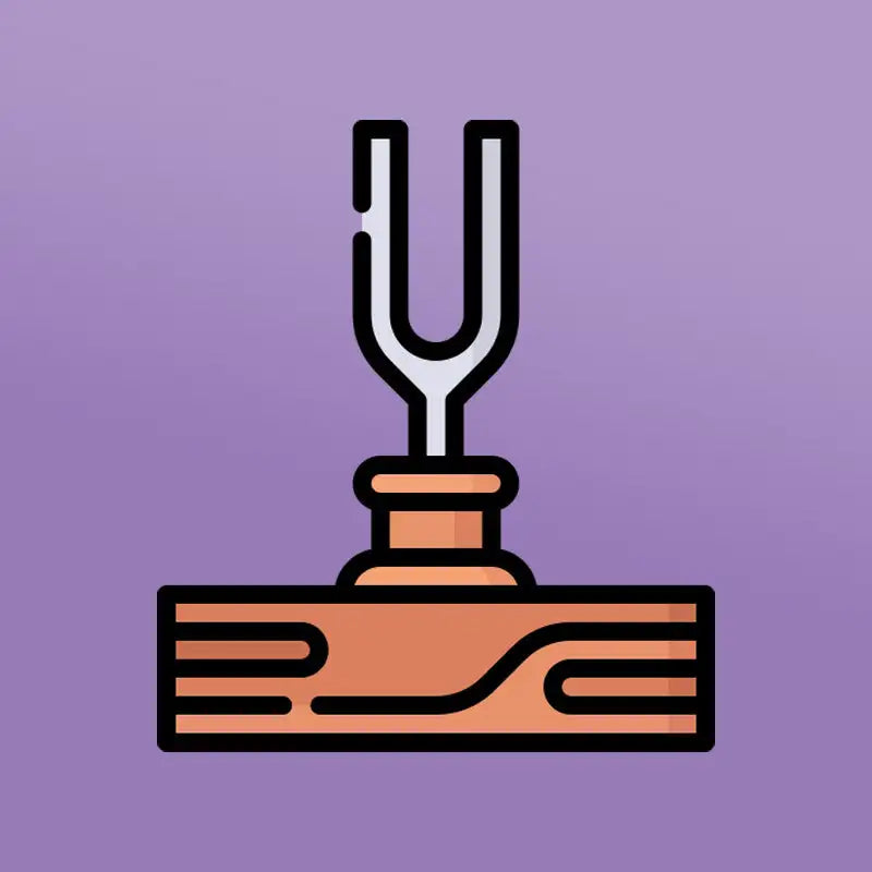 Silver tuning fork resting on a wooden base.