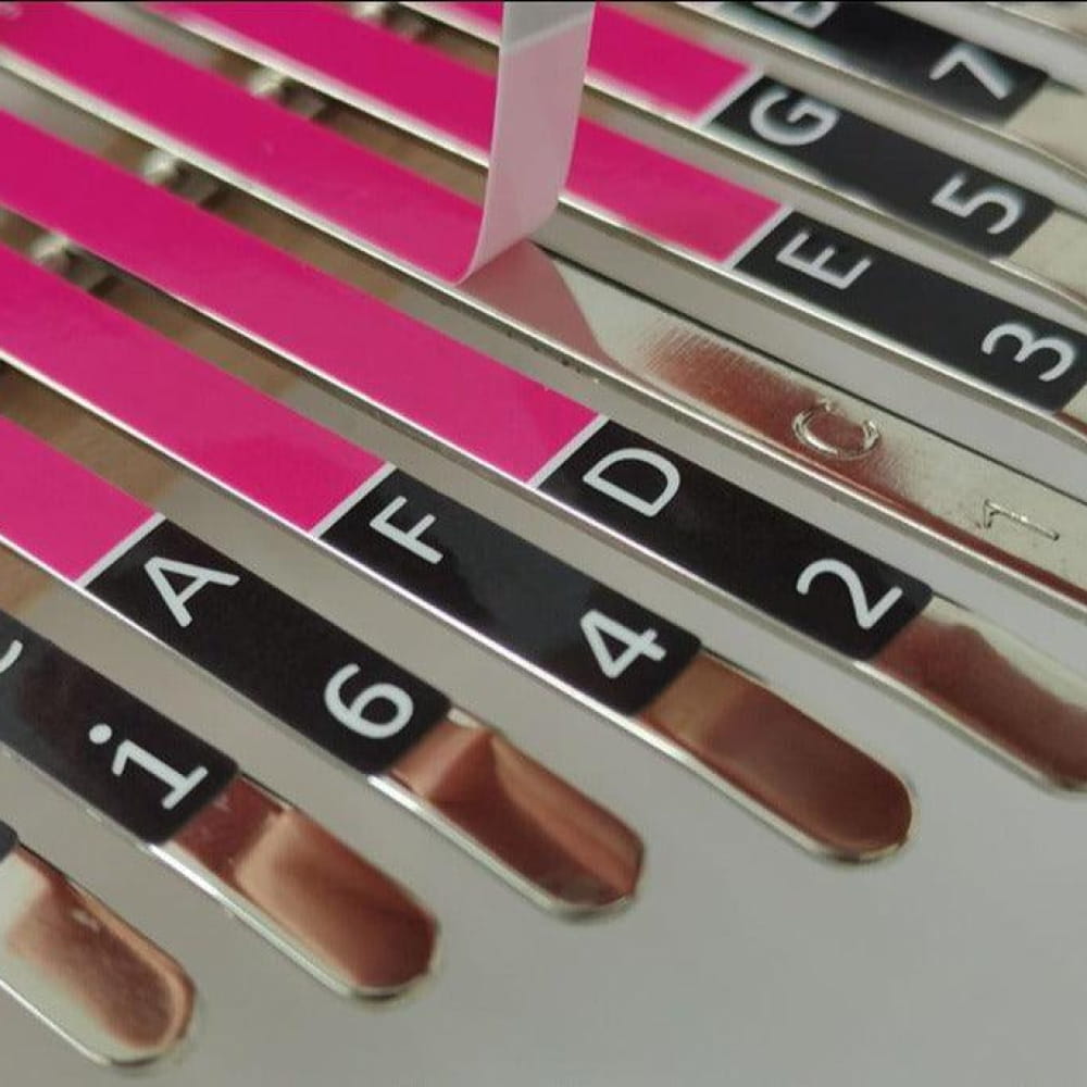 Metal tuning forks with pink and black frequency markers from Versatile Thumb Piano Set