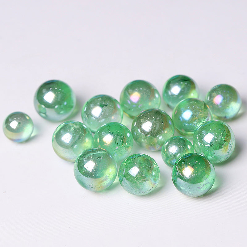 Iridescent green glass pebbles from the Aura Green Crystal Sphere healing orb