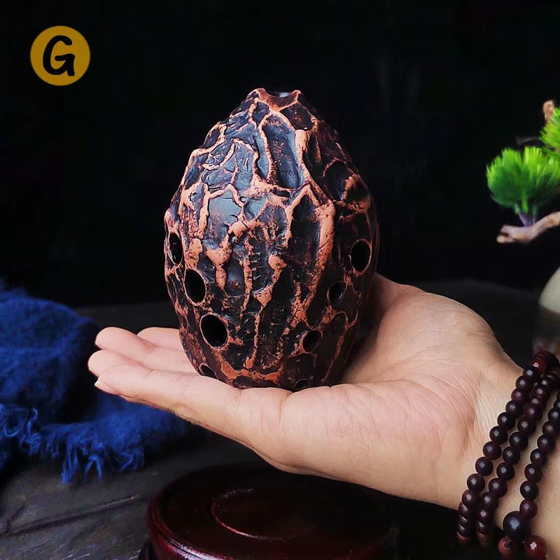 Decorative copper egg with lattice pattern on 10-Hole Pottery Xun musical instrument