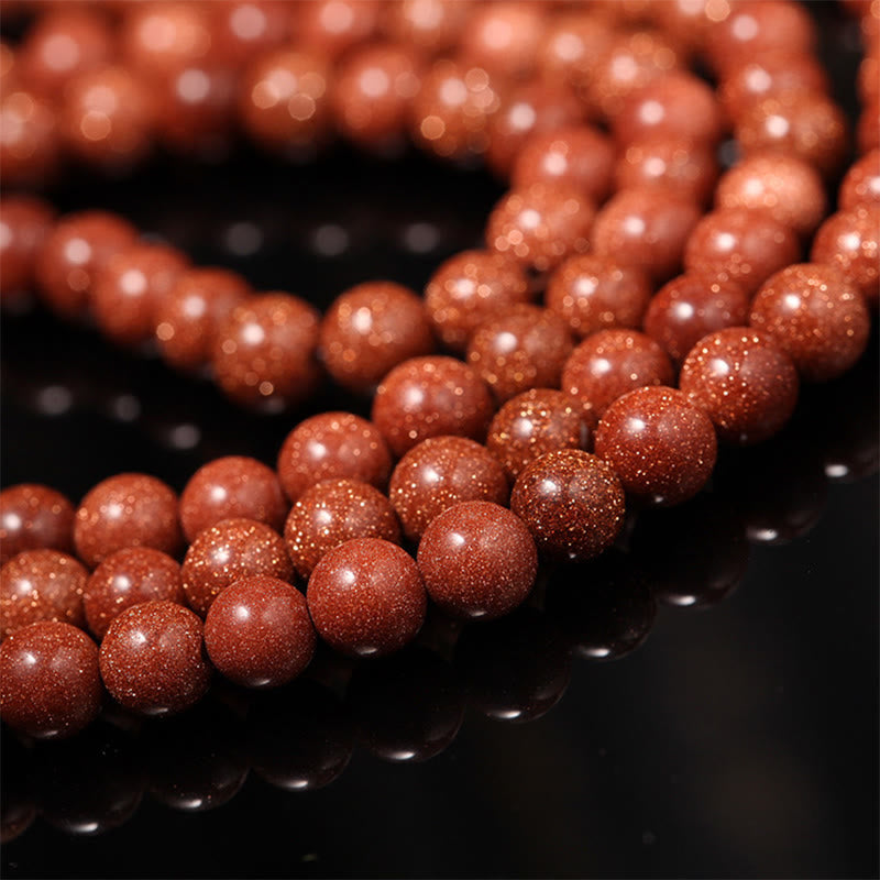 Bracelet Mala en pierres précieuses Goldstone à 108 perles pour plus de confiance