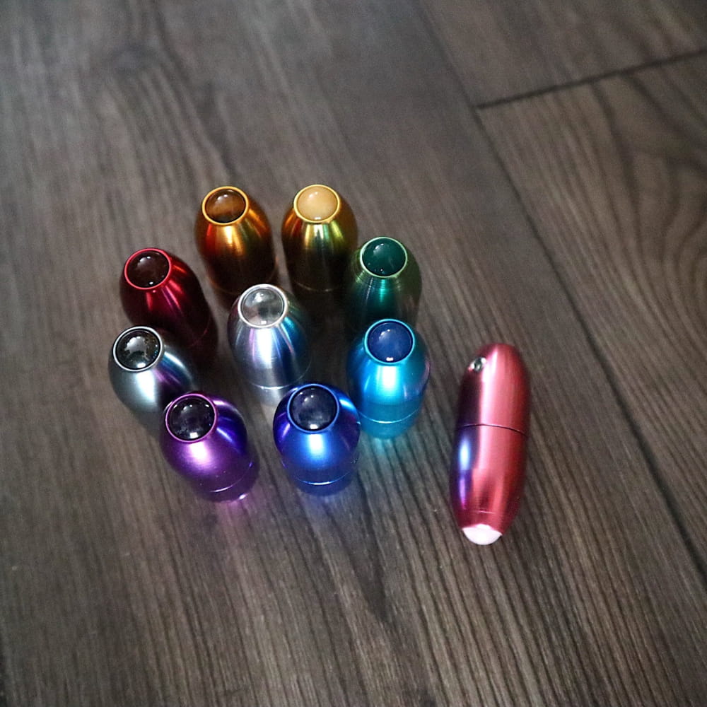 Colorful metallic tuning forks arranged in a circle for massage and biofield therapy