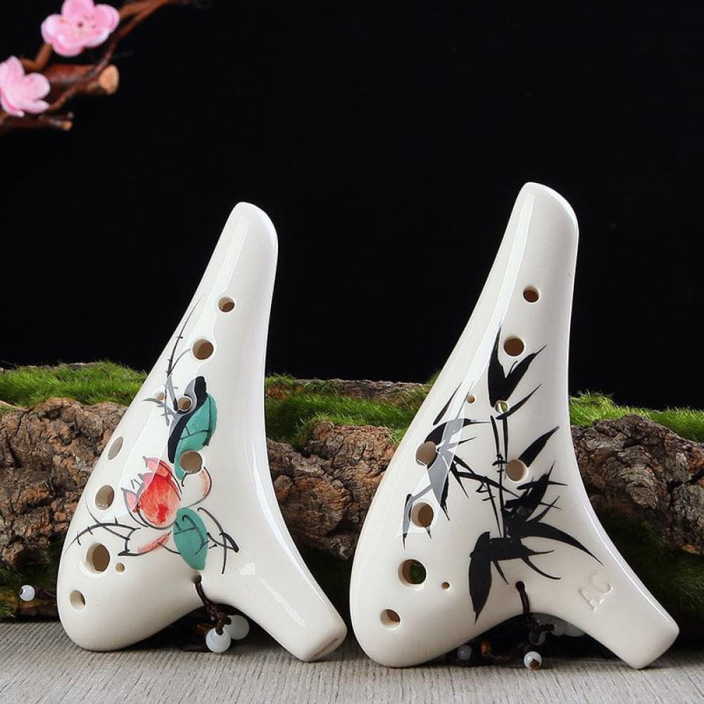 Two white ceramic ocarinas with floral and bamboo designs for beginners