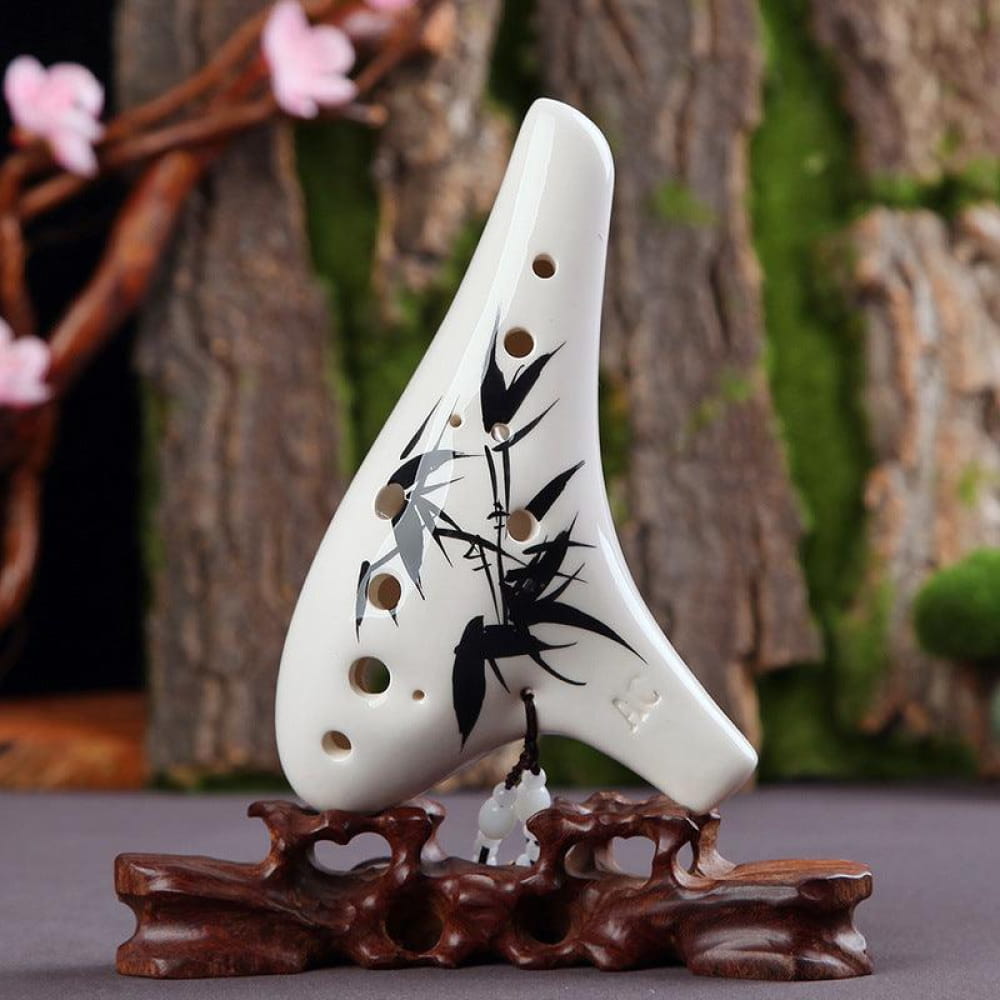 White ceramic 12 Hole Alto C Ocarina with bamboo design on wooden stand