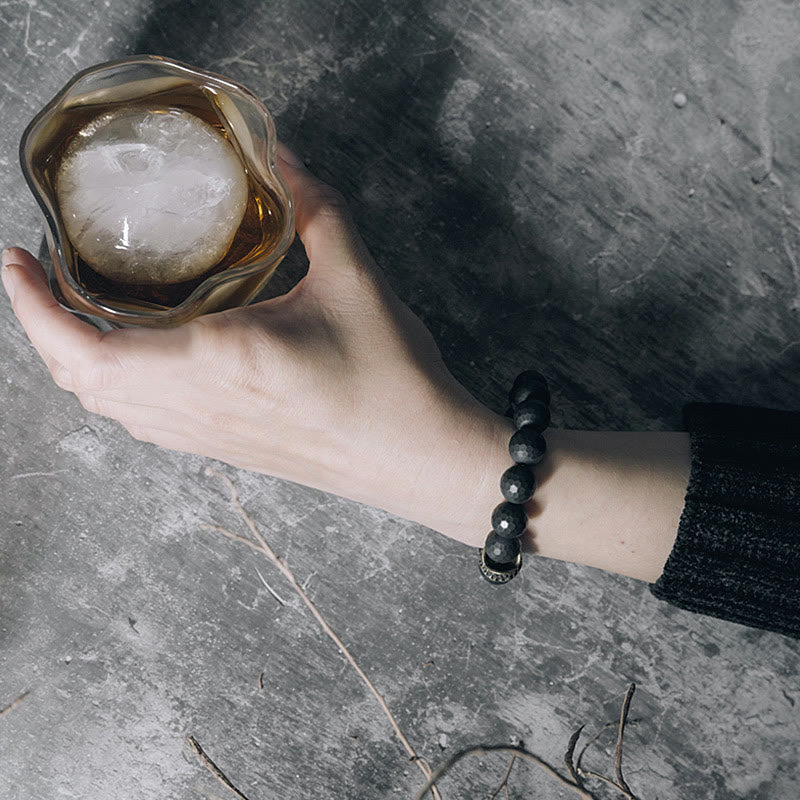 Bracelet de protection en onyx noir 12 mm avec accents cuivrés | Sons de guérison