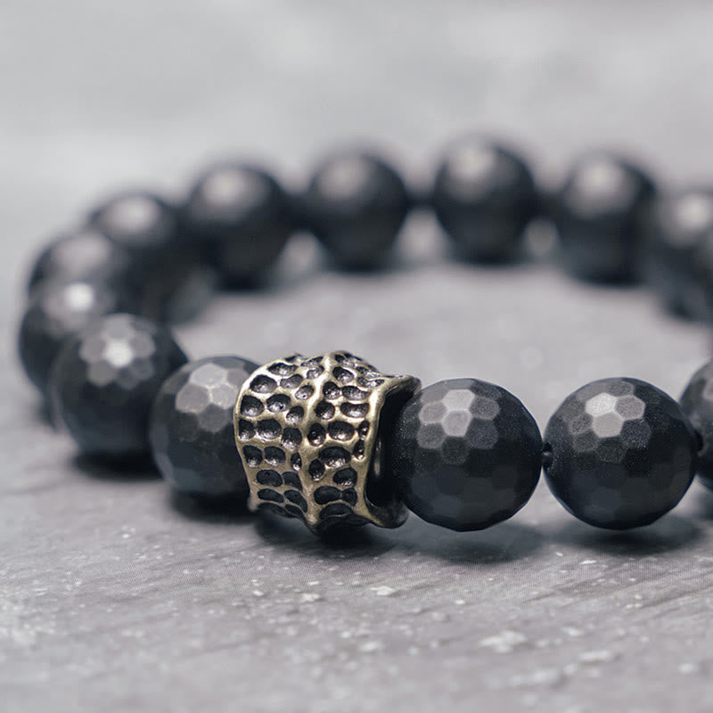 Bracelet de protection en onyx noir 12 mm avec accents cuivrés | Sons de guérison