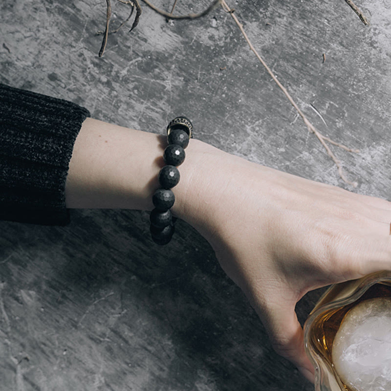 Bracelet de protection en onyx noir 12 mm avec accents cuivrés | Sons de guérison
