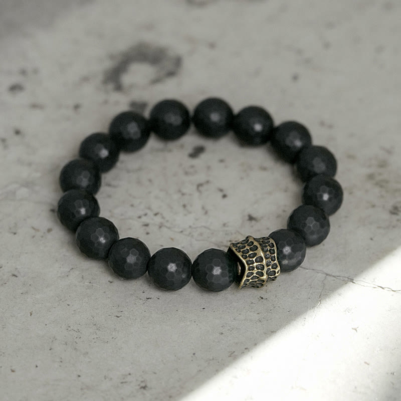 Bracelet de protection en onyx noir 12 mm avec accents cuivrés | Sons de guérison