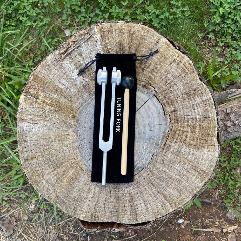 Tuning fork with wooden mallet in black velvet pouch for 136.10 Hz sound therapy