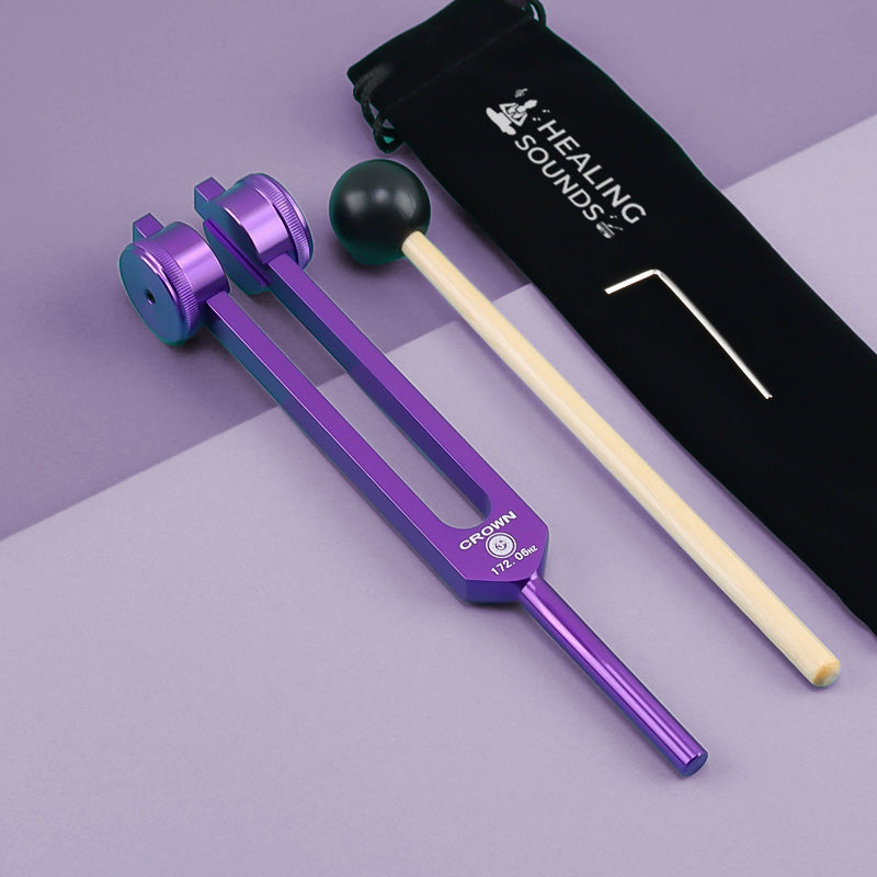 Purple metallic tuning fork with adjustable weights for 172.06 Hz Crown Chakra healing