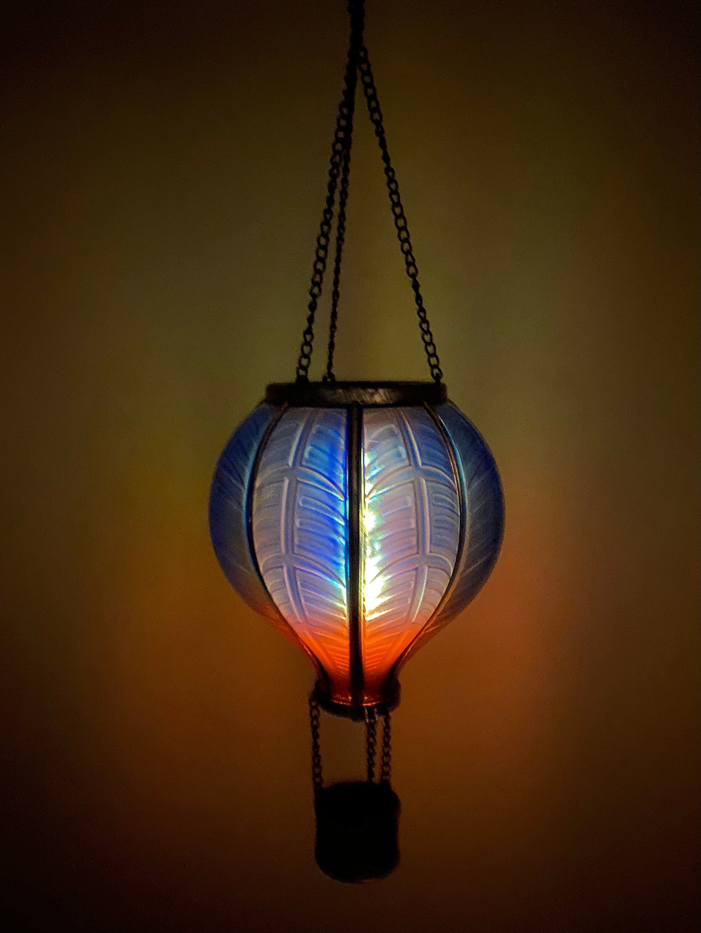 Illuminated hot air balloon-shaped hanging lamp with colorful panels for outdoor decor