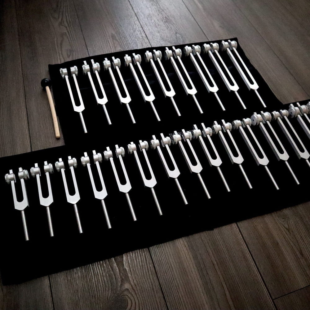 Collection of tuning forks on black fabric for the 24pc Solfeggio Tuning Fork Set