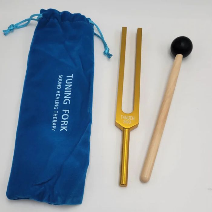 Gold-colored 300 Hz tuning fork with blue pouch and mallet for Dan Tien energy healing