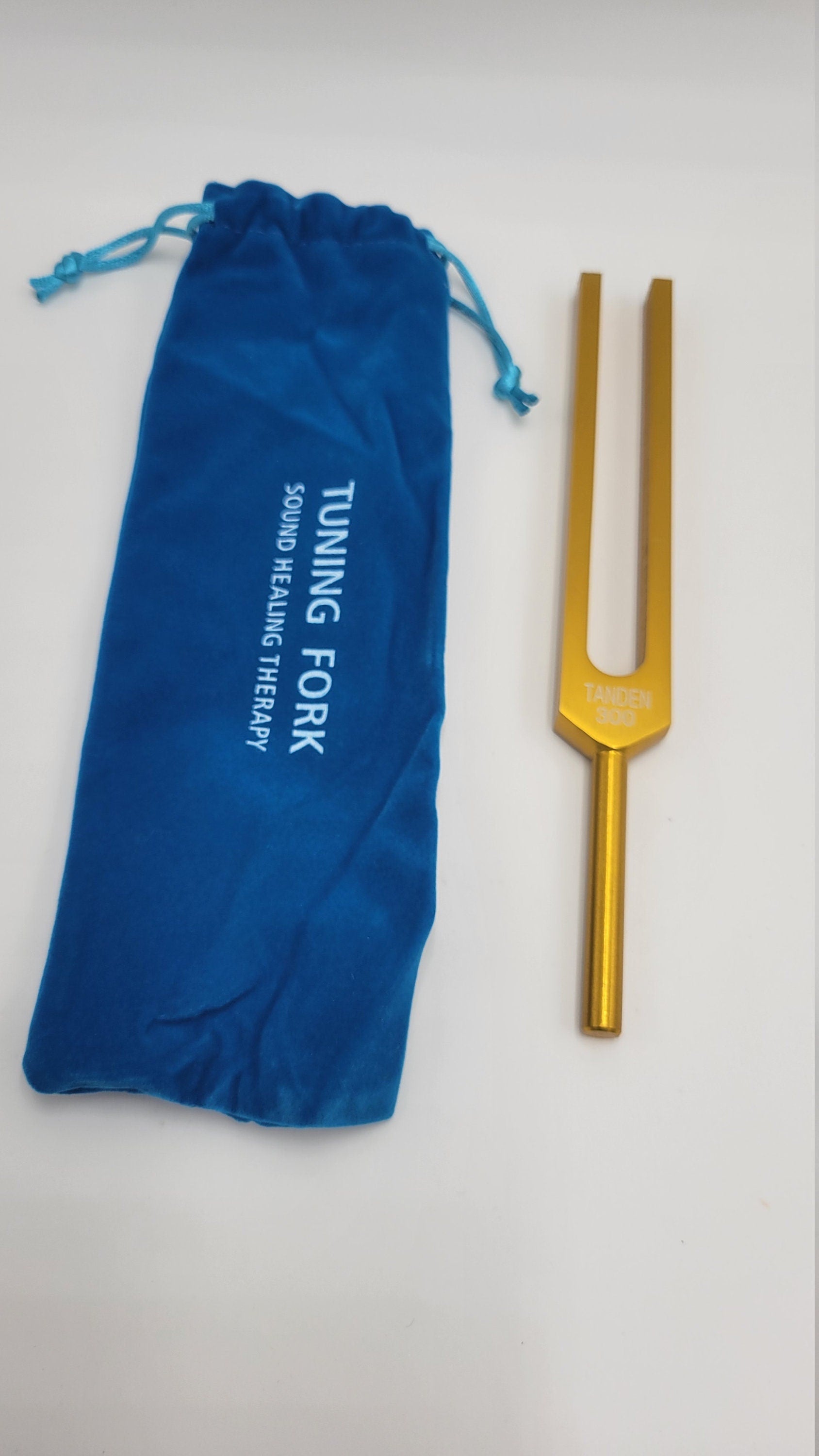 Golden tuning fork with blue pouch for 300 Hz Dan Tien Energy Healing