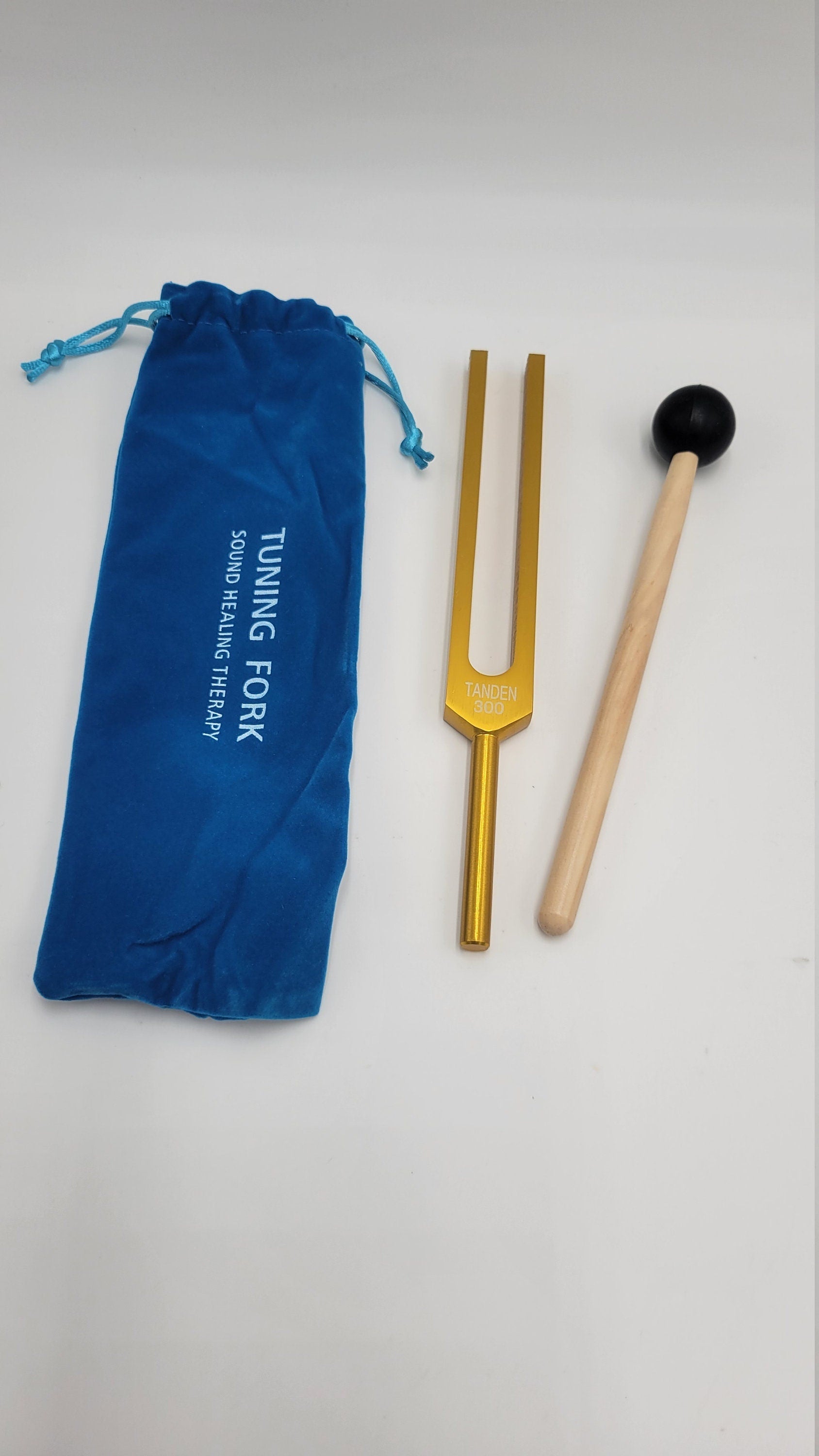 Golden tuning fork with mallet and blue pouch for 300 Hz Dan Tien Energy Healing