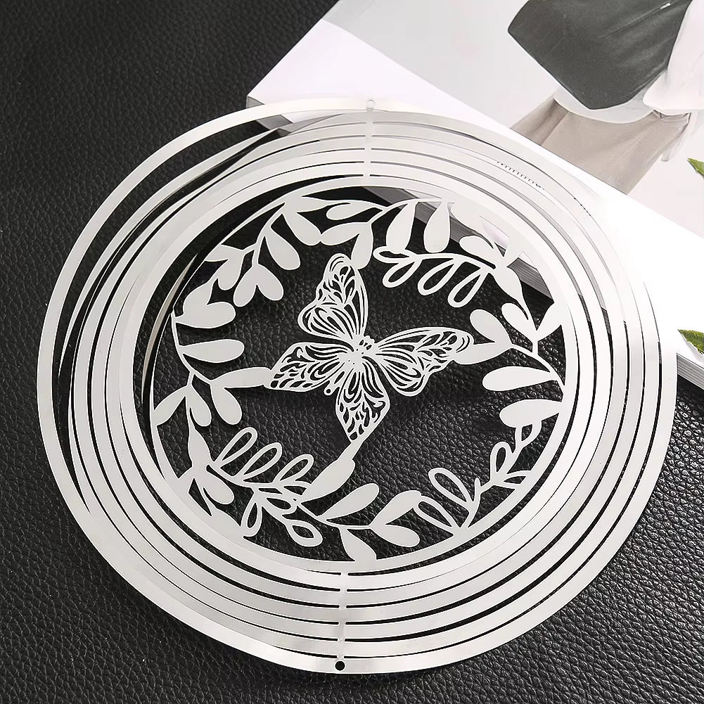 Circular metal wind spinner featuring a butterfly and leaf design for outdoor decor