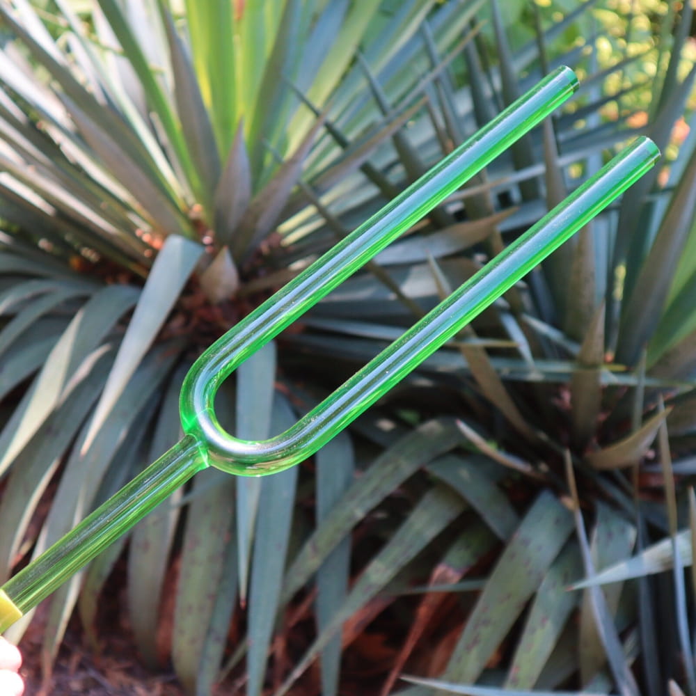 Green plastic drinking straw U-shape next to 432 Hz Giant Large Crystal Tuning Fork