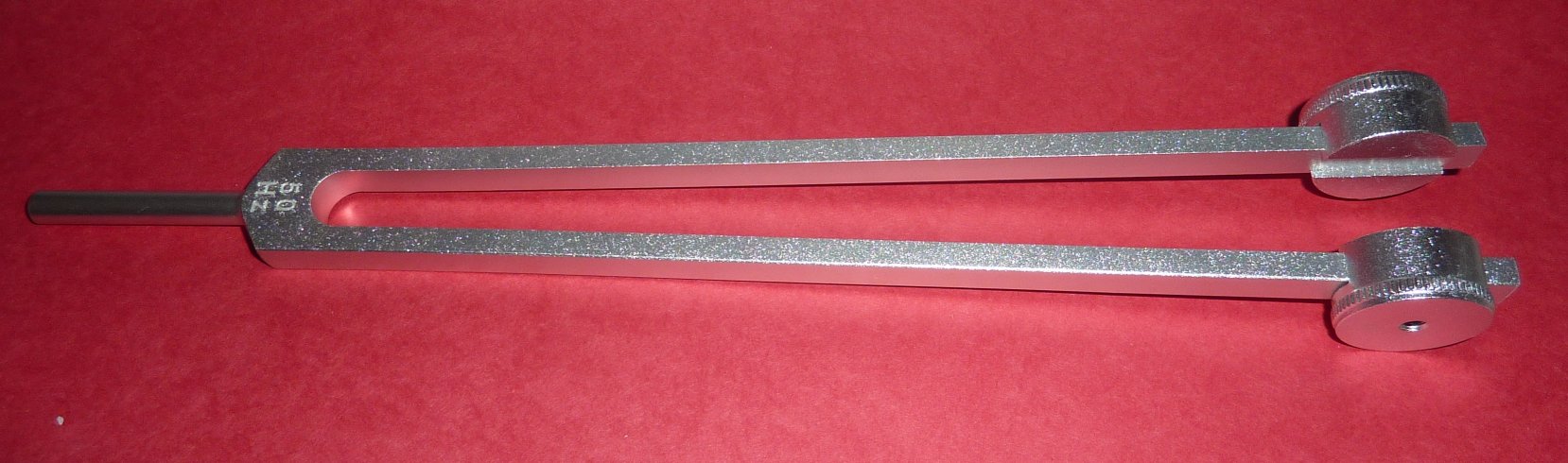 Two long metal tongs parallel to each other for 50 Hz Weighted Nerve Tuning Fork