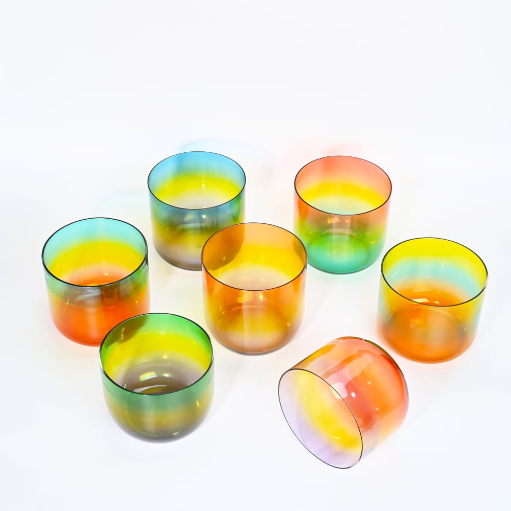 Colorful iridescent glass tea light holders in a gradient rainbow effect set