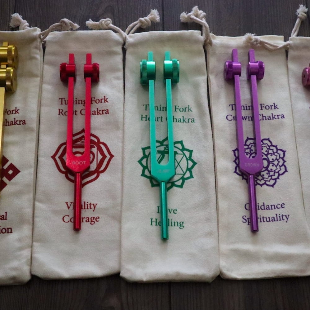 Colorful tuning forks with chakra symbols in pouches for 741 Hz healing and intuition