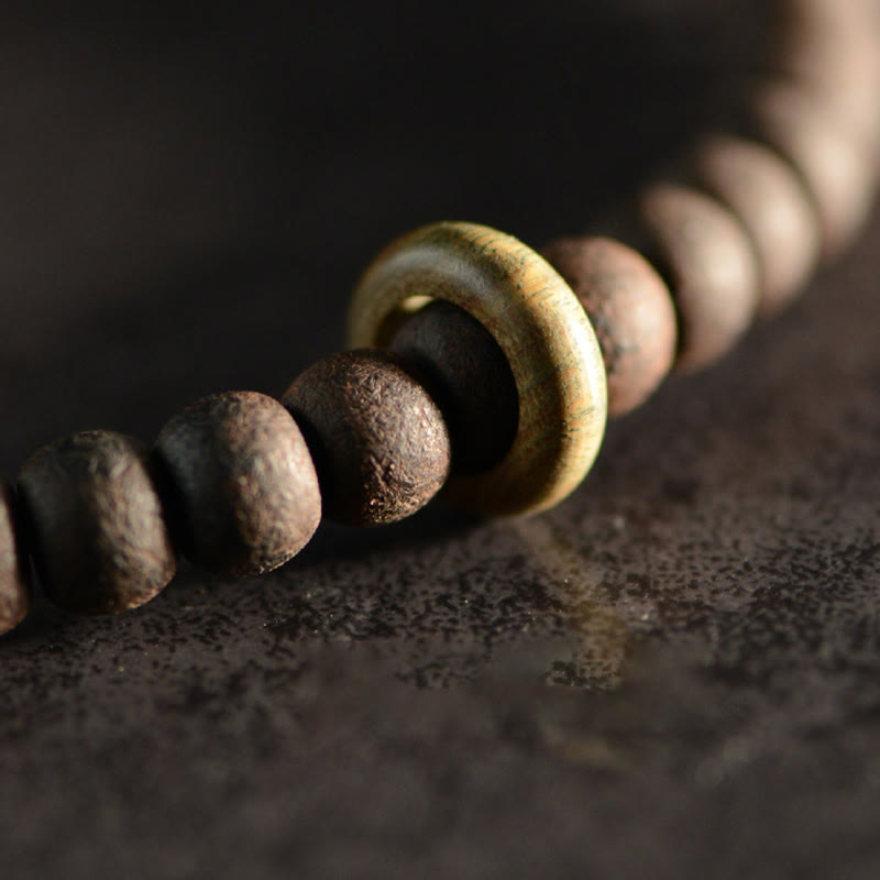 Bracelet spirituel double tour en bois d'ébène et perles Dzi à 9 œillets