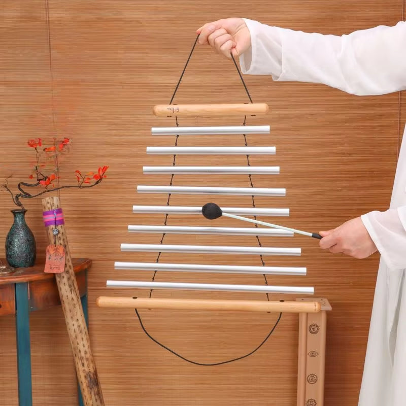 White hanging xylophone mallet being played on 9 notes Equilibrium Swing Chimes