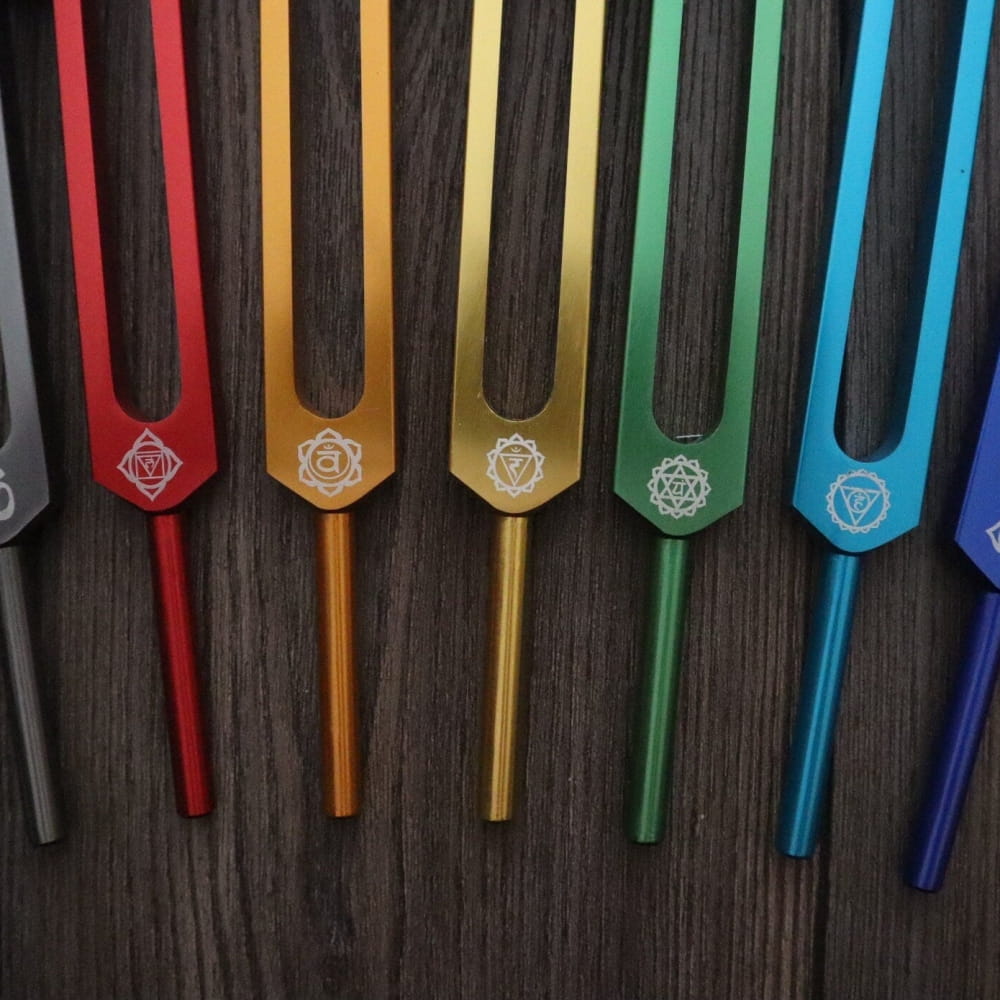 Colorful tuning forks in rainbow spectrum with chakra symbols for sound healing