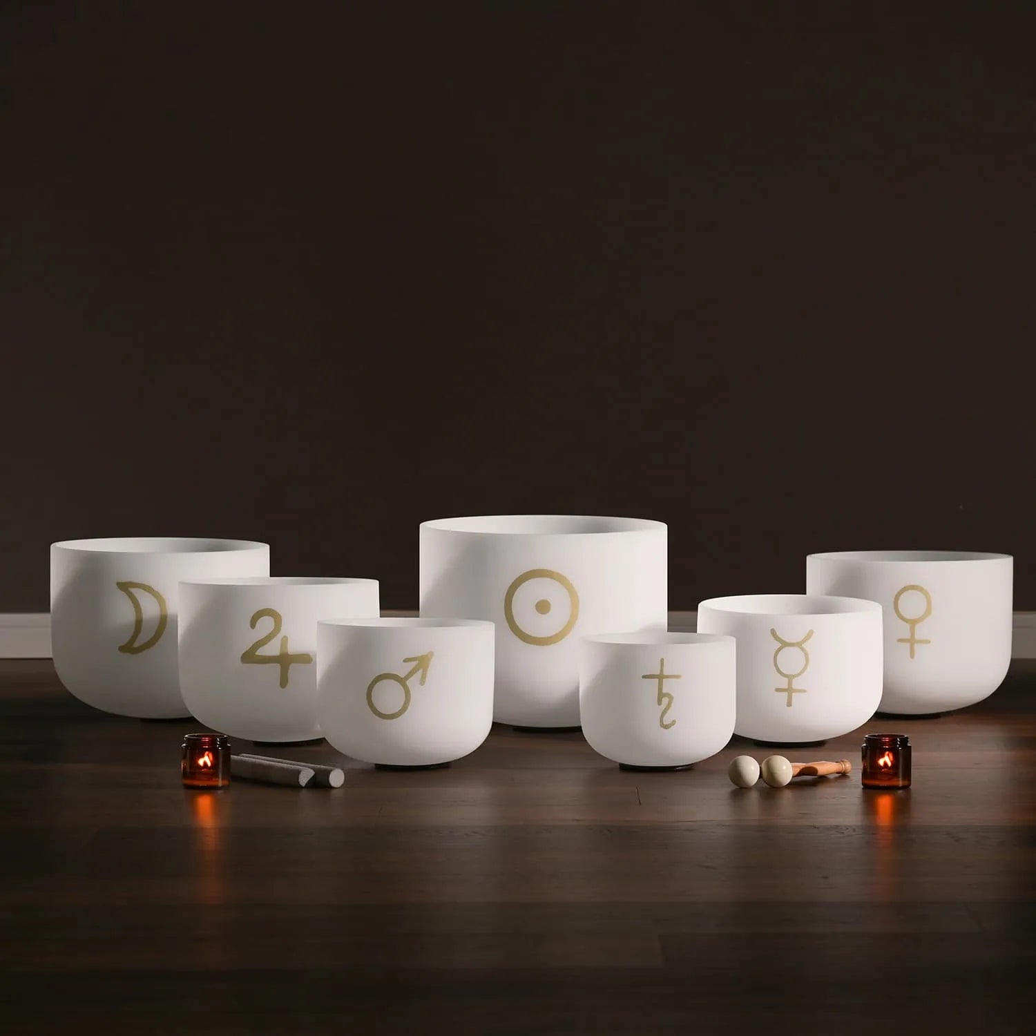 White crystal singing bowls with gold astrological symbols in 7-piece set