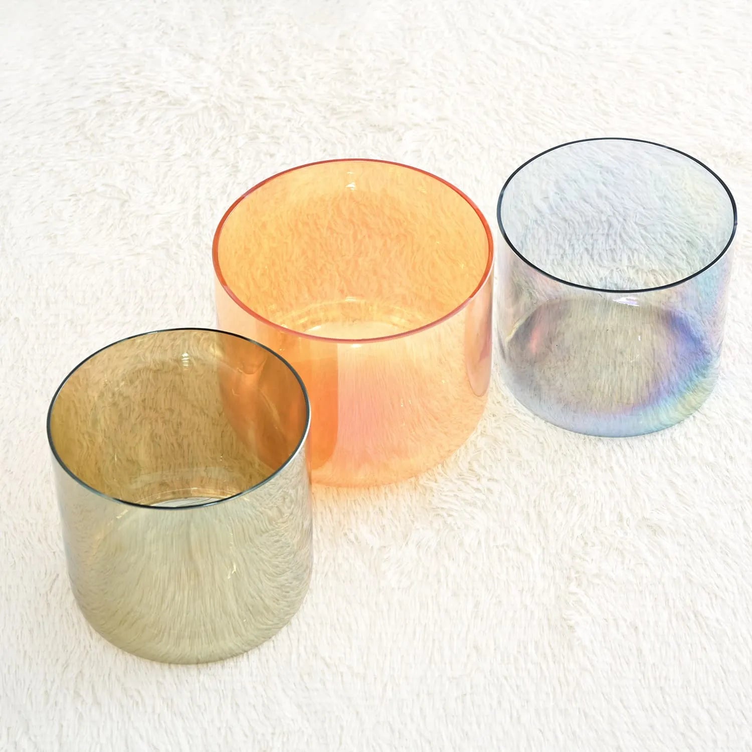 Translucent glass tumblers in peach, silver, and blue for Alchemy Clear Crystal Singing Bowls