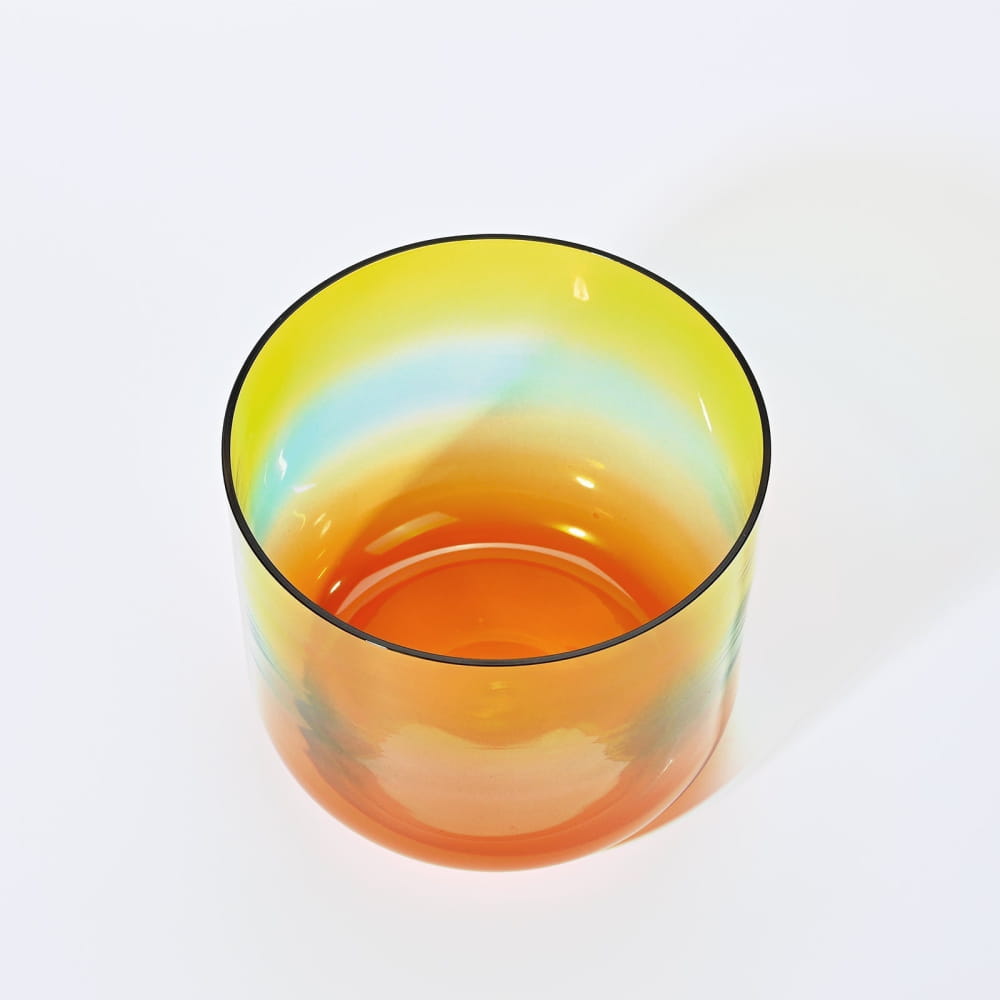 Colorful glass vessel with gradient shades of yellow and orange for Alchemy Clear Rainbow E Note Crystal Singing Bowl