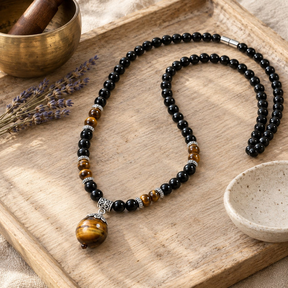 Black Obsidian Tiger Eye Necklace for Protection & Strength, styled with a singing bowl and lavender