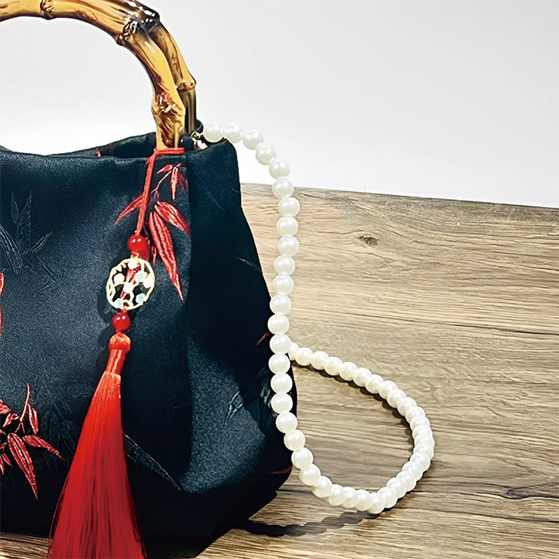 Sac en polyester et coton noir brodé de feuilles avec poignée en bambou