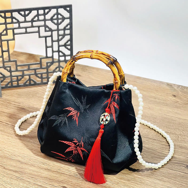 Sac en polyester et coton noir brodé de feuilles avec poignée en bambou