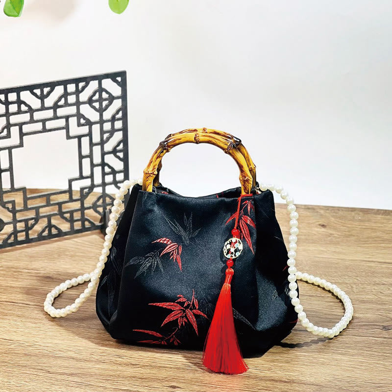 Sac en polyester et coton noir brodé de feuilles avec poignée en bambou