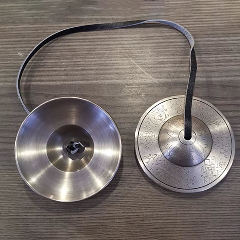 Brass Buddha Hand Cymbals connected by a cord for meditation practice and harmony