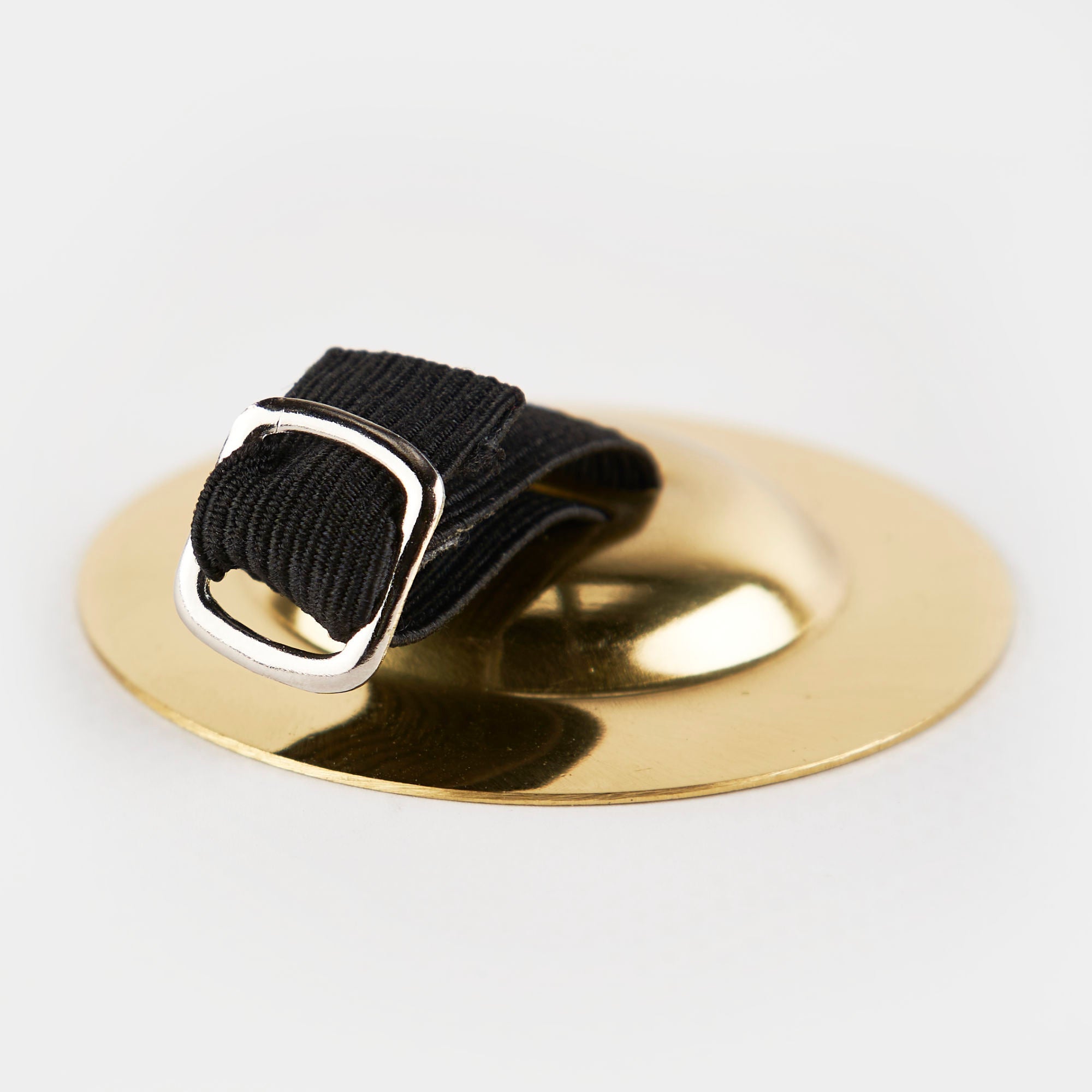 Black strap with silver buckle on gold surface for Buddha Hand Finger Cymbals