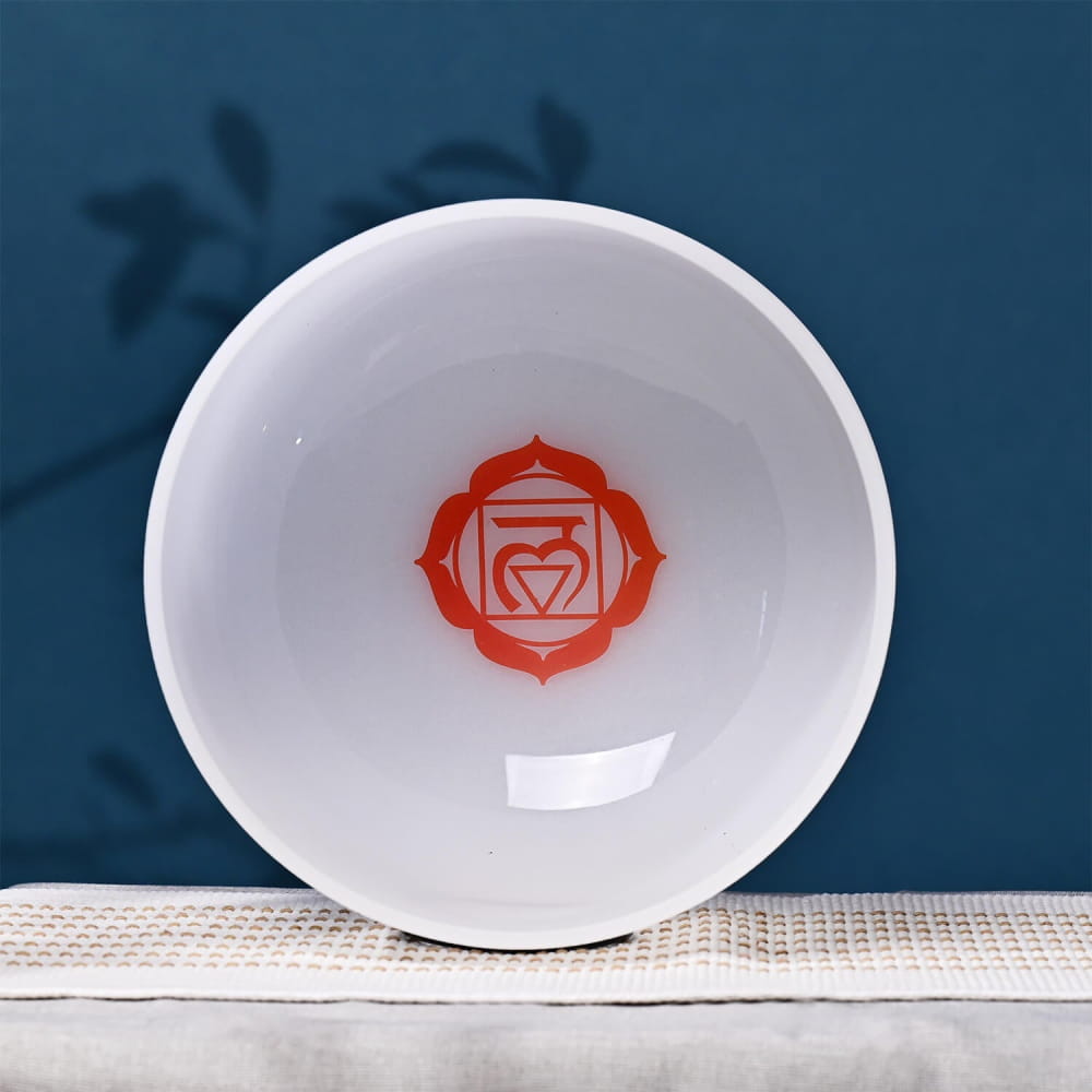 White ceramic bowl with orange root chakra symbol for meditation and healing