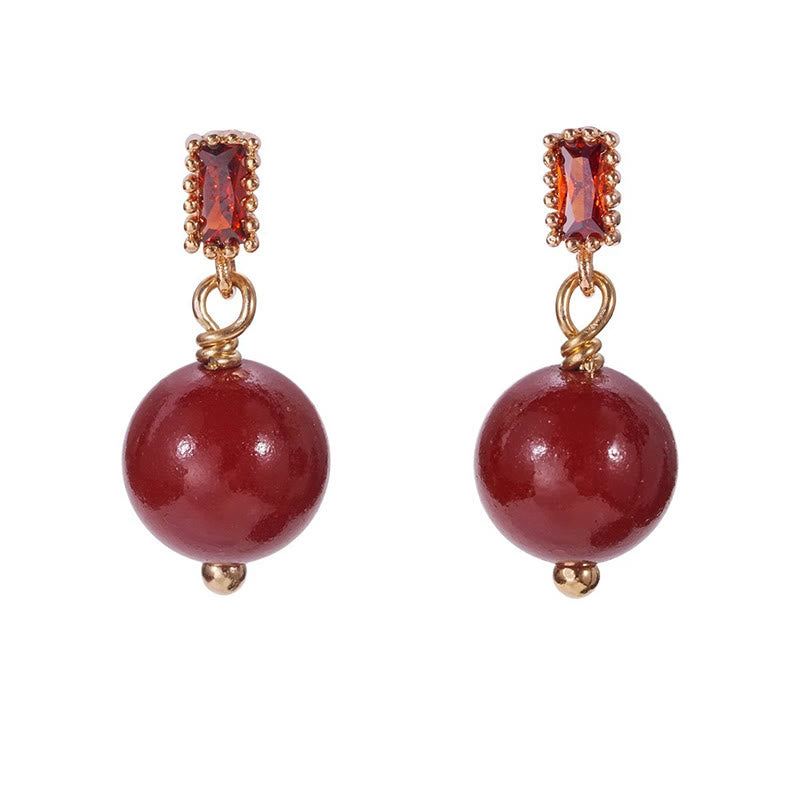 Boucles d'oreilles cinabre, tiges en argent 925 et perles calmes en or 14 carats