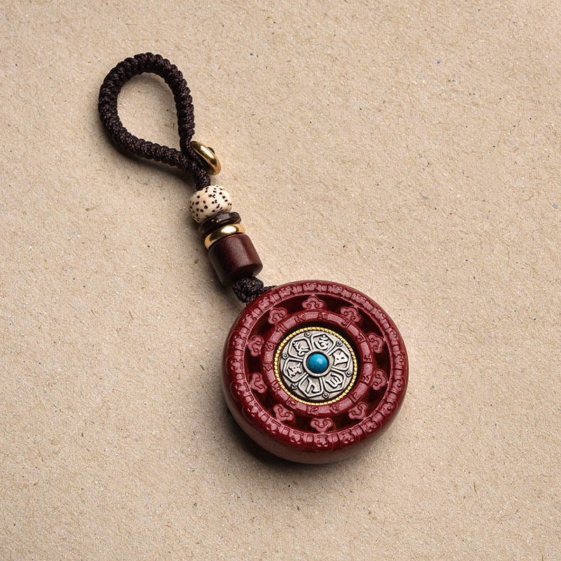 Collier pendentif rotatif et porte-clés Cinabre Om Mani Padme Hum
