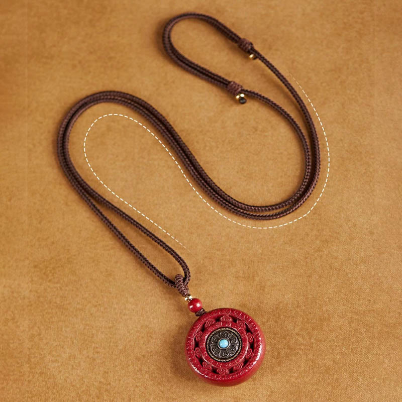 Collier pendentif rotatif et porte-clés Cinabre Om Mani Padme Hum